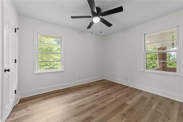 unfurnished room with light wood finished floors, baseboards, and ceiling fan