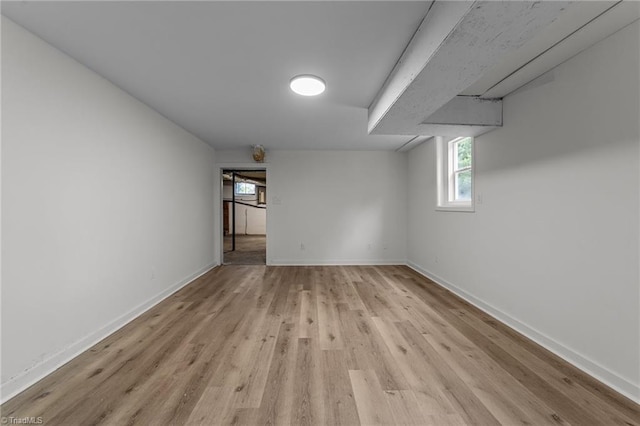 basement with light wood finished floors, plenty of natural light, and baseboards