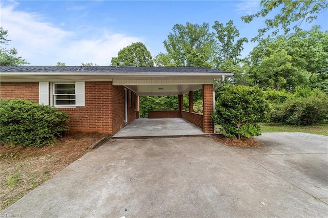 view of parking / parking lot with driveway and an attached carport