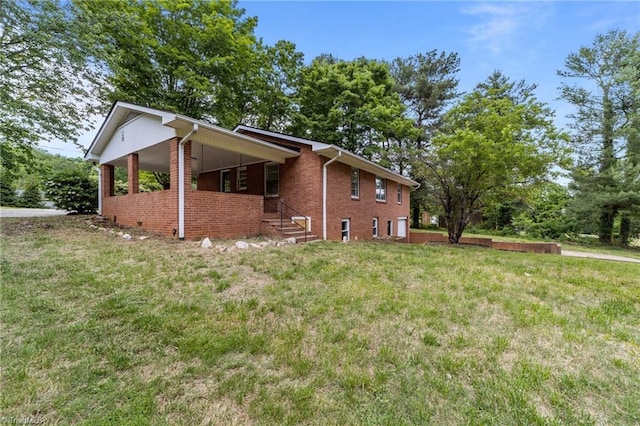 view of side of property featuring a lawn and brick siding