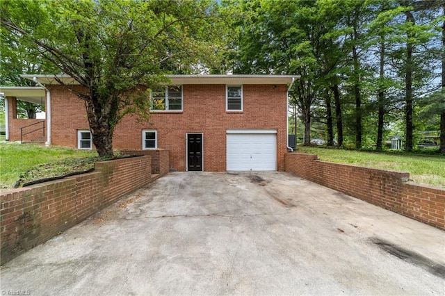 view of home's exterior with an attached garage, driveway, and brick siding