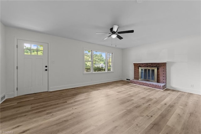 unfurnished living room featuring plenty of natural light, a ceiling fan, baseboards, and light wood finished floors