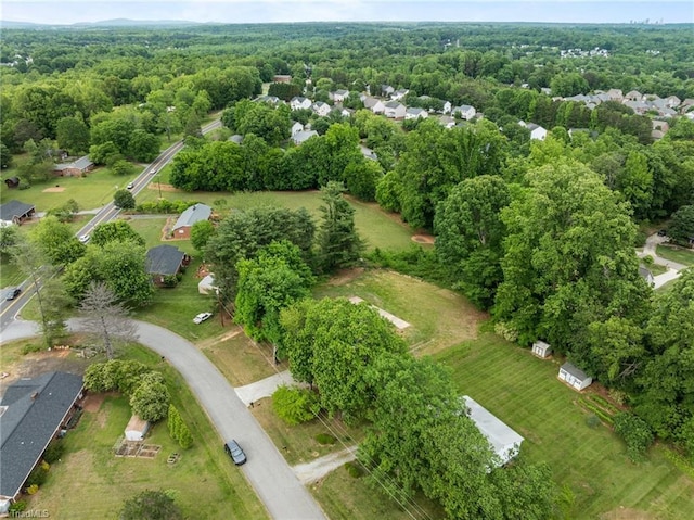 aerial overview of property's location with a heavily wooded area