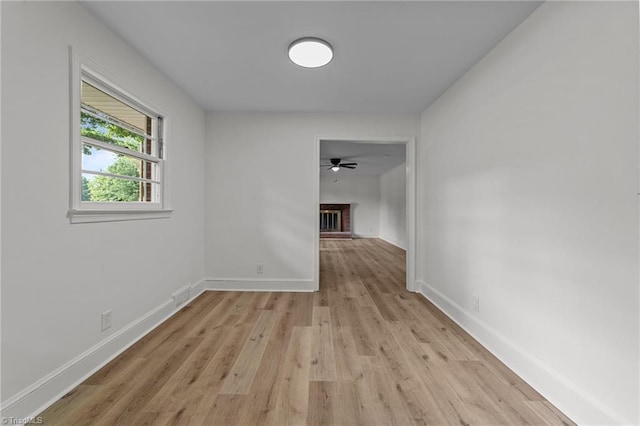 hall featuring light wood-type flooring and baseboards