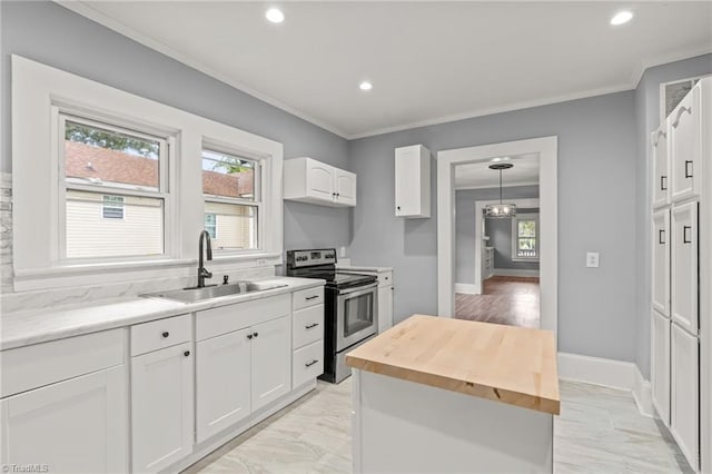 kitchen featuring pendant lighting, wood counters, sink, white cabinetry, and stainless steel electric range oven