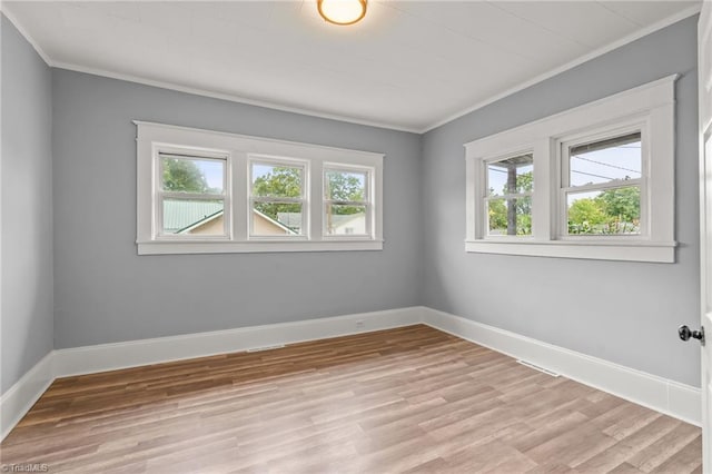 empty room with light hardwood / wood-style flooring and ornamental molding