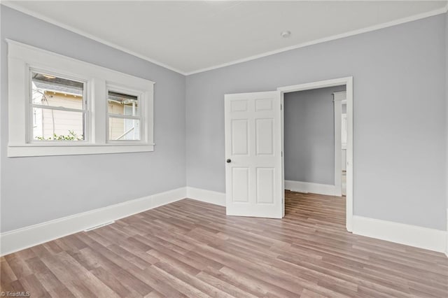 unfurnished bedroom featuring light wood-type flooring and crown molding