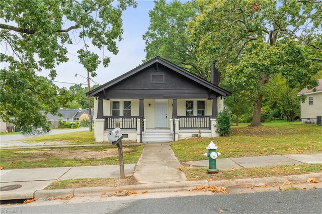 bungalow-style house with a front lawn and a porch