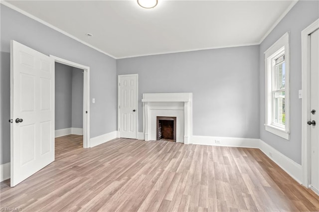 unfurnished living room featuring light hardwood / wood-style flooring and ornamental molding