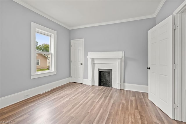 unfurnished living room with light hardwood / wood-style flooring and crown molding