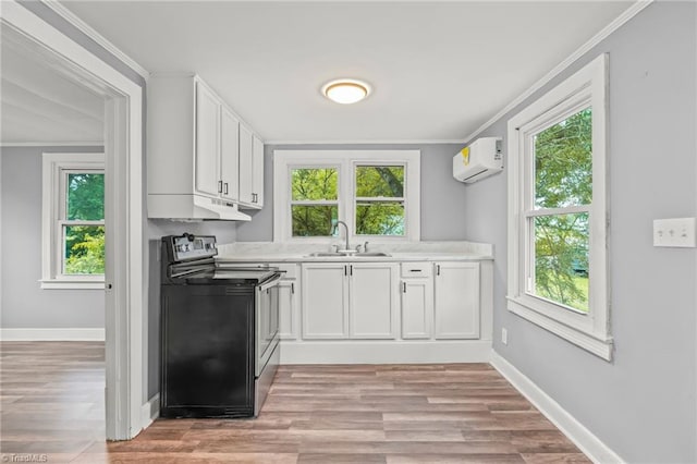 kitchen featuring light wood-type flooring, sink, range with electric cooktop, and white cabinetry