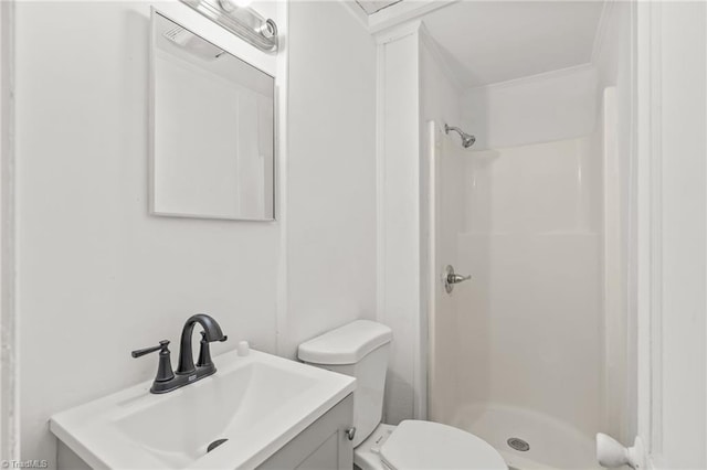 bathroom featuring walk in shower, vanity, and toilet