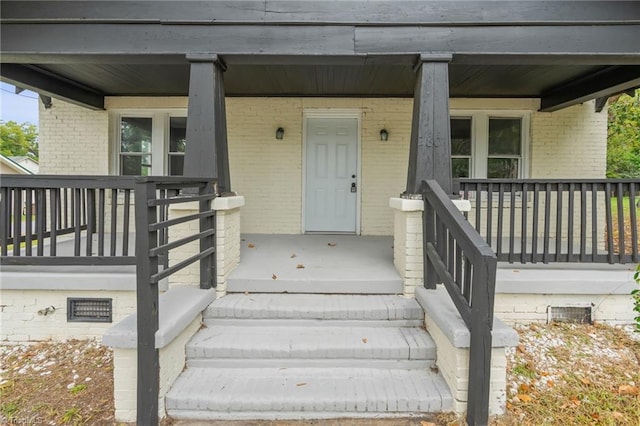 view of exterior entry with a porch