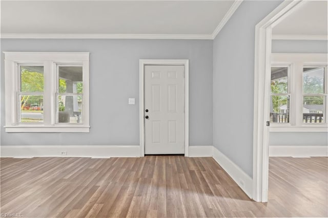 foyer with light hardwood / wood-style flooring and crown molding