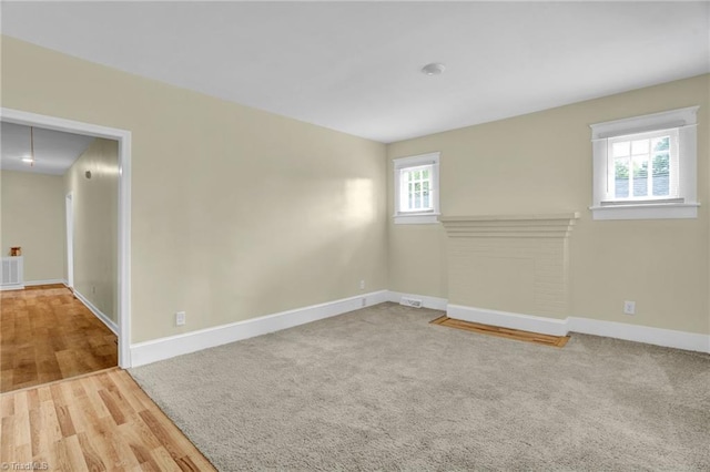 unfurnished room with light wood-type flooring and a healthy amount of sunlight