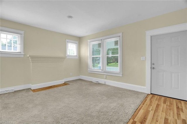 empty room featuring plenty of natural light and light wood-type flooring