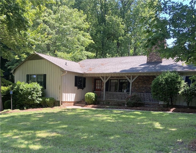 1229 Woodbrook Dr, Kernersville, NC 27284 - ranch-style house featuring a porch, a front lawn, a chimney, a shingled roof, and board and batten siding