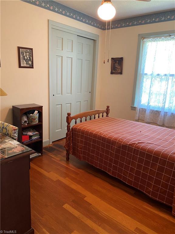 1229 Woodbrook Dr, Kernersville, NC 27284 - bedroom featuring wood finished floors and a closet