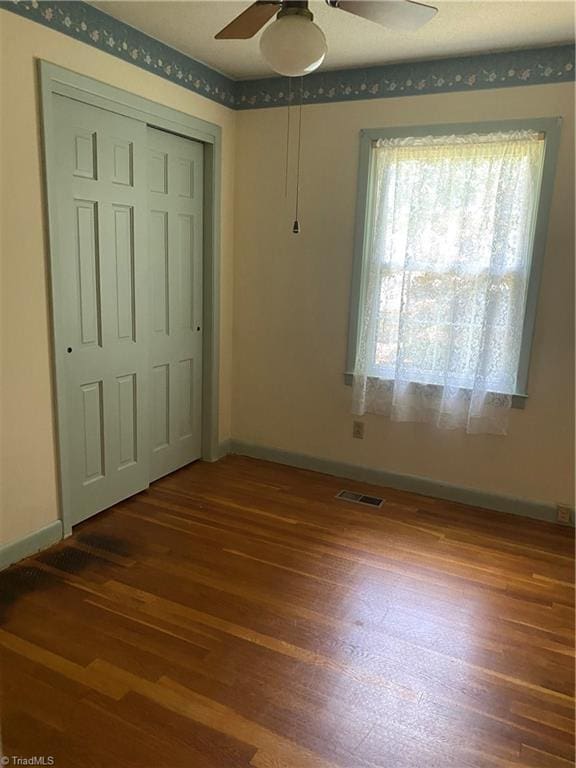 1229 Woodbrook Dr, Kernersville, NC 27284 - unfurnished bedroom featuring wood finished floors, baseboards, and a closet