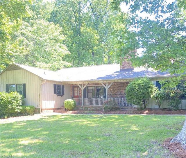 1229 Woodbrook Dr, Kernersville, NC 27284 - ranch-style house featuring a chimney, covered porch, a front lawn, and board and batten siding