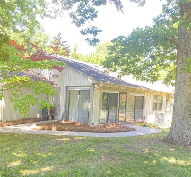 1229 Woodbrook Dr, Kernersville, NC 27284 - rear view of house with a lawn, a sunroom, and central AC