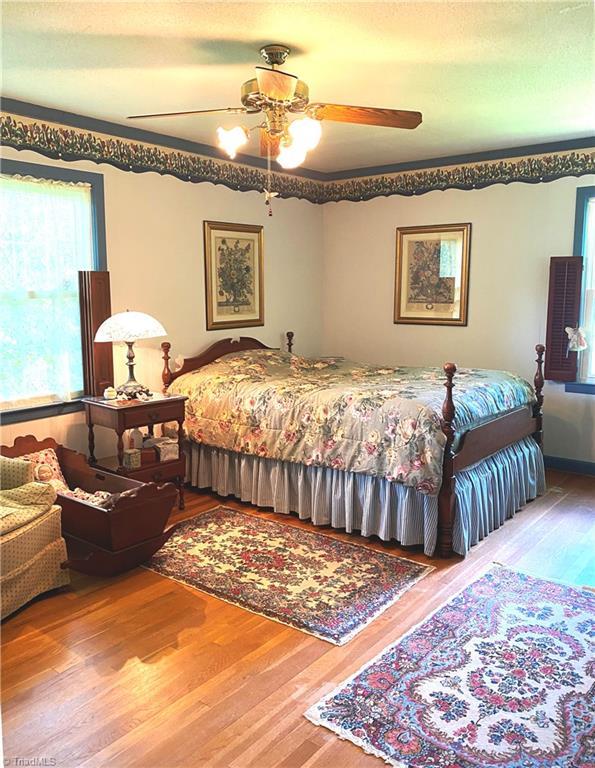 1229 Woodbrook Dr, Kernersville, NC 27284 - bedroom featuring wood finished floors and ceiling fan