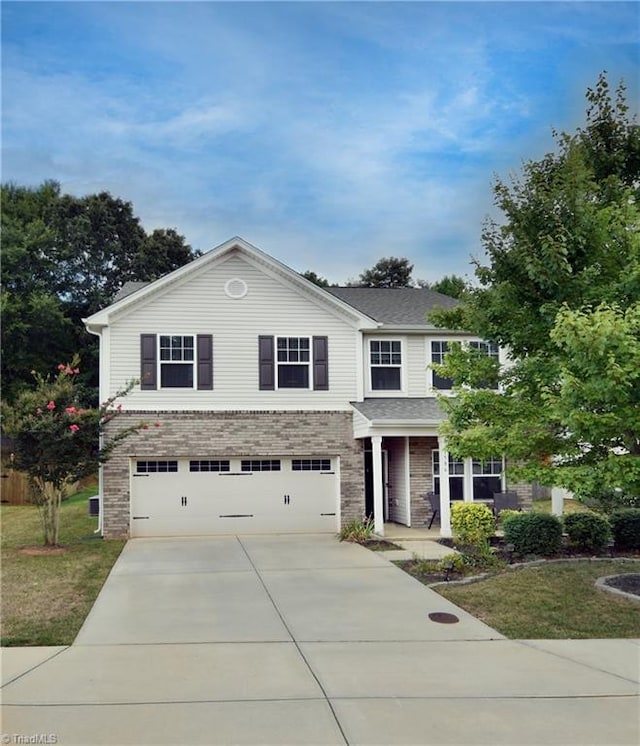 view of property with a front yard and a garage