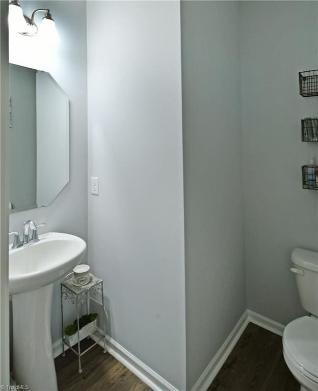 bathroom featuring sink, hardwood / wood-style floors, and toilet