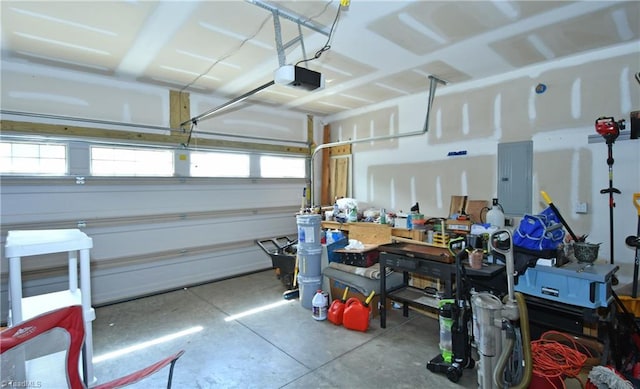 garage with electric panel and a garage door opener