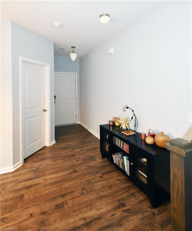 corridor featuring dark hardwood / wood-style flooring