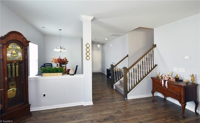 foyer entrance with a notable chandelier and dark wood-type flooring