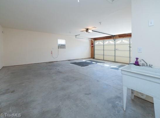 garage featuring a garage door opener and a sink