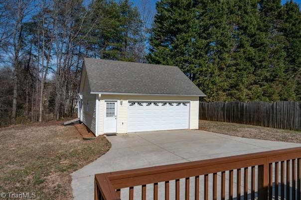 detached garage featuring fence