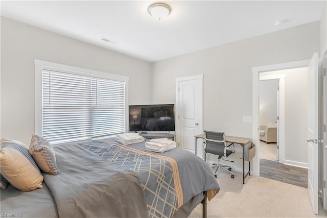 bedroom featuring visible vents, carpet floors, and baseboards