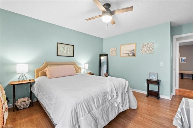 bedroom with hardwood / wood-style flooring and ceiling fan