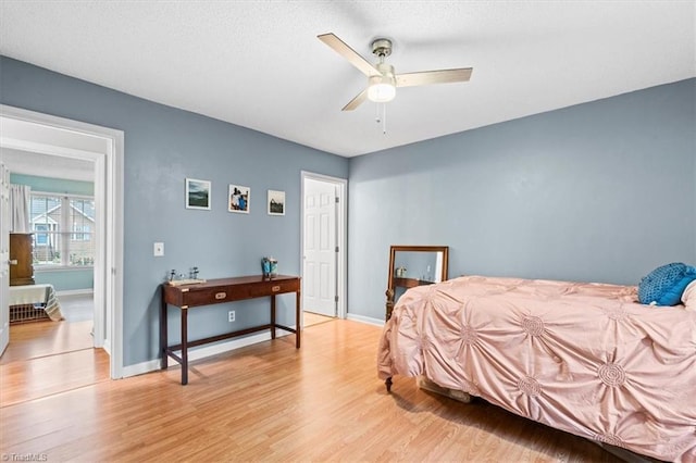 bedroom with ceiling fan and light hardwood / wood-style flooring