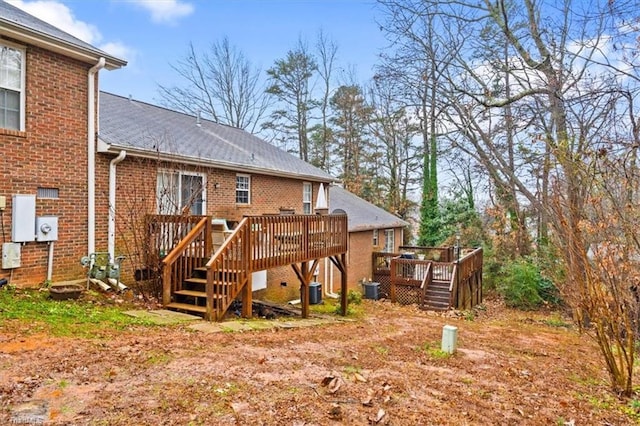 back of property with central air condition unit and a wooden deck