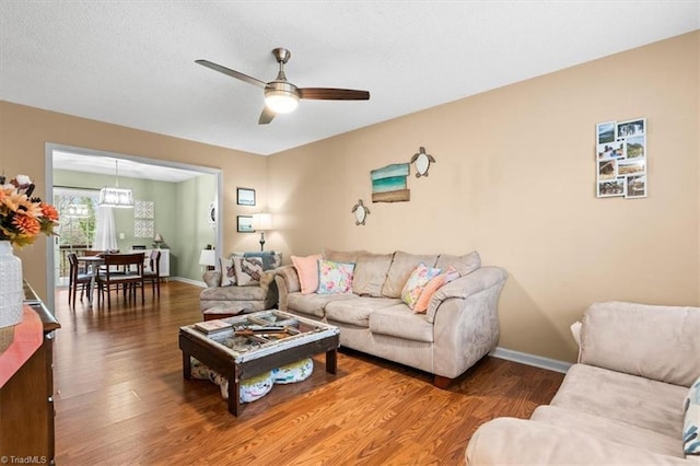 living room with wood-type flooring and ceiling fan