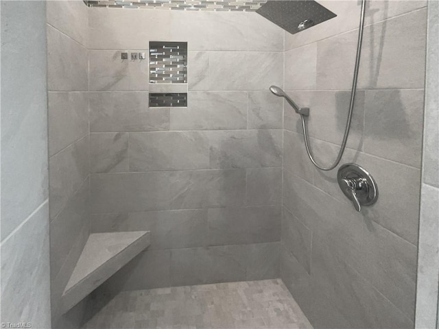 full bath featuring a tile shower