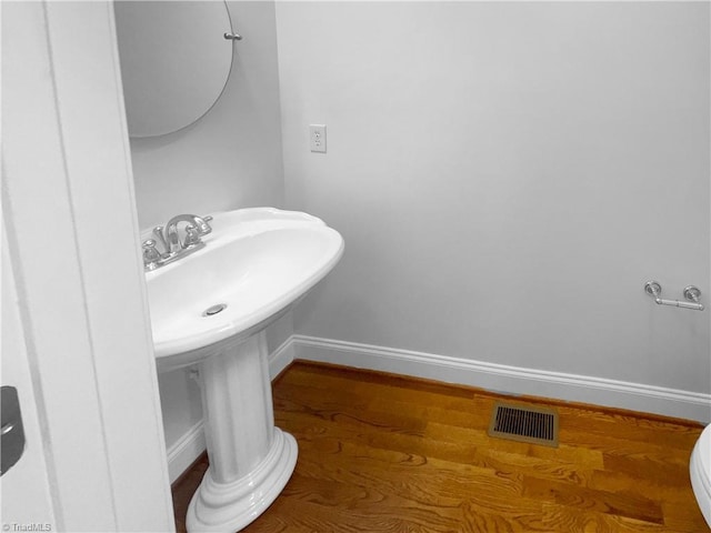 bathroom featuring baseboards and wood finished floors