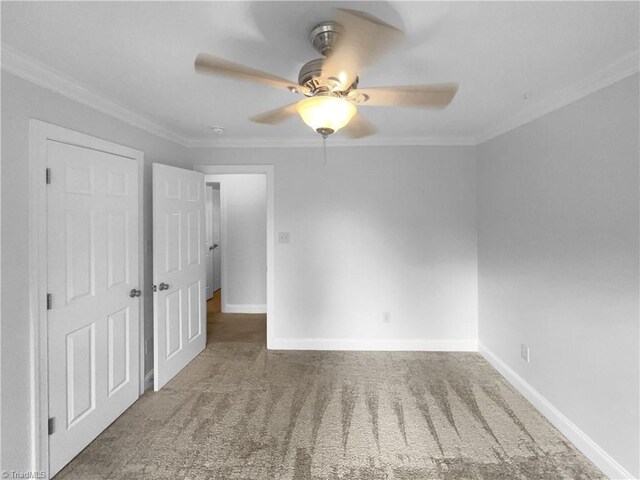 unfurnished bedroom with carpet, crown molding, baseboards, and ceiling fan