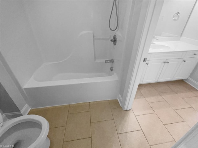 bathroom featuring tile patterned floors, vanity, shower / bathtub combination, baseboards, and toilet