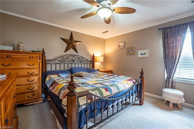 bedroom with crown molding, a textured ceiling, visible vents, and carpet