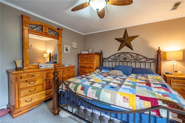 carpeted bedroom featuring crown molding, a ceiling fan, visible vents, and a textured ceiling