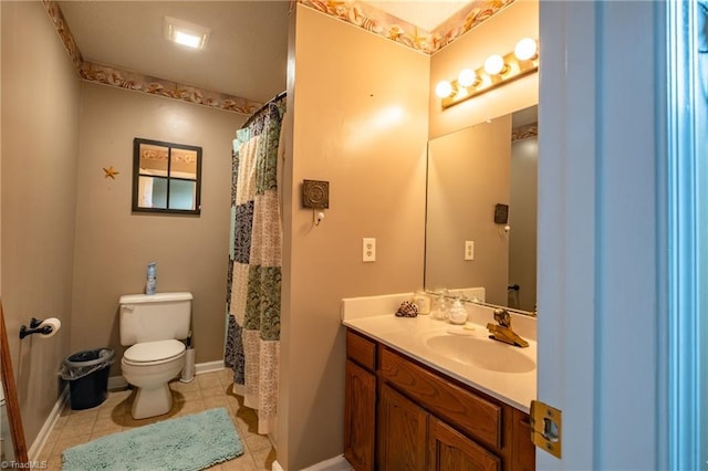 bathroom featuring tile patterned floors, vanity, toilet, and baseboards