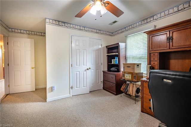 office area with visible vents, ceiling fan, light carpet, and baseboards