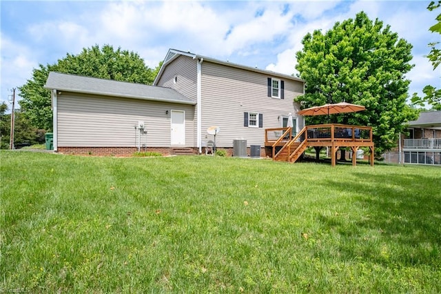 rear view of house featuring a deck, central AC, and a yard