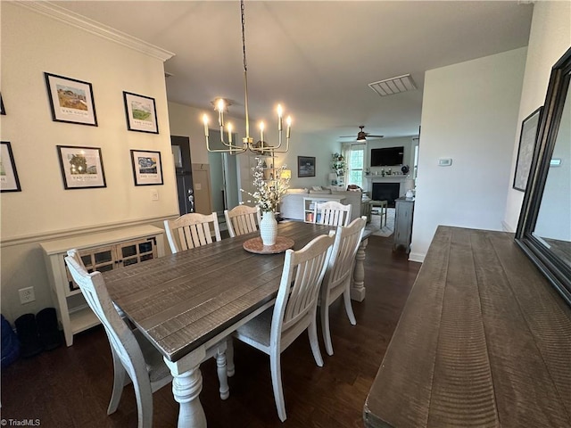 107 Saddlebrook Dr, Advance, NC 27006 - dining room with wood finished floors, a chandelier, ceiling fan, and a fireplace