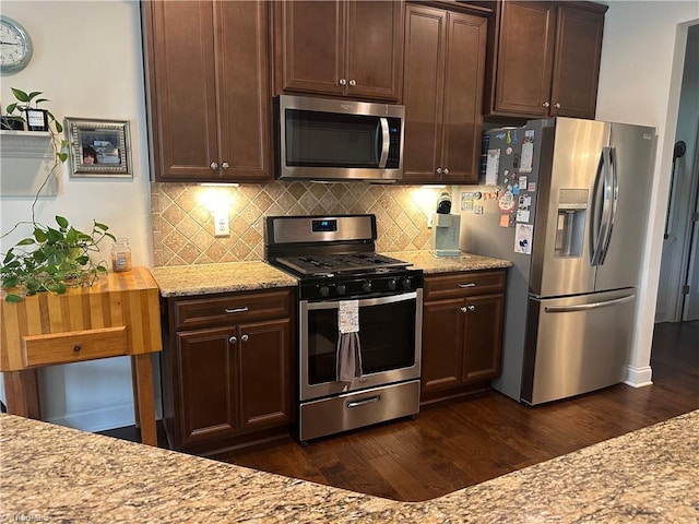 107 Saddlebrook Dr, Advance, NC 27006 - kitchen with appliances with stainless steel finishes, dark wood-style flooring, tasteful backsplash, and light stone counters