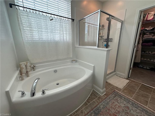 107 Saddlebrook Dr, Advance, NC 27006 - bathroom featuring a shower stall, a garden tub, and a walk in closet